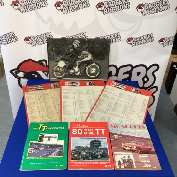 Vintage Isle of Man TT programs and Champion spark plug charts collection.