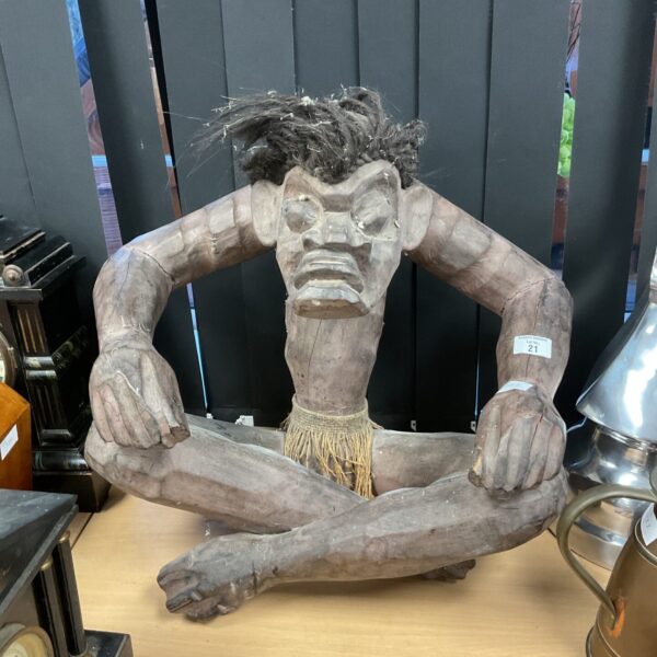 Large carved hardwood tribal figure with textured details.