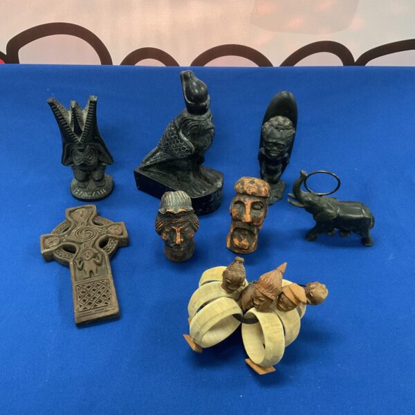 Vintage carved ornaments collection featuring wood and stone figurines.