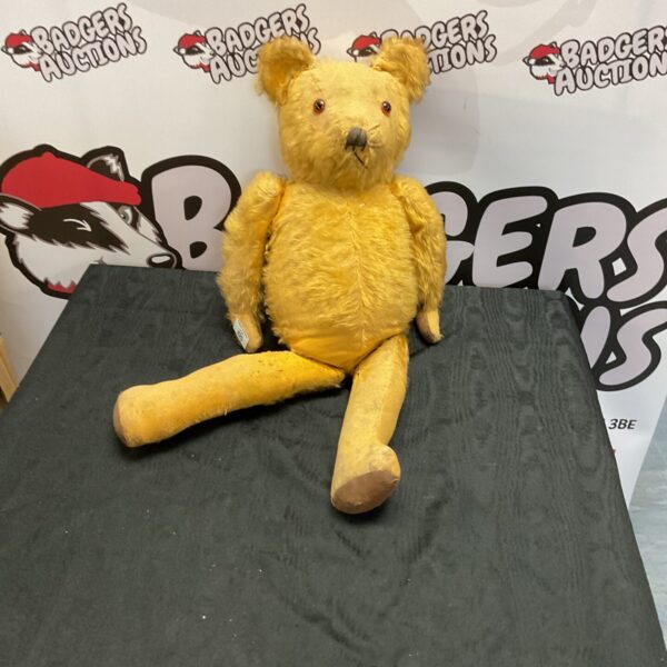 Golden mohair vintage teddy bear with jointed limbs.