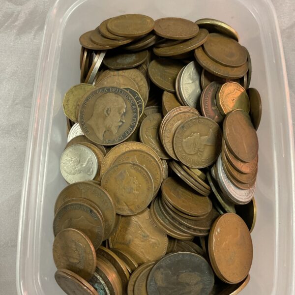 Assorted British coins in a plastic tub, including penny coins.