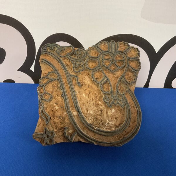 Antique art nouveau printing block with detailed floral design.
