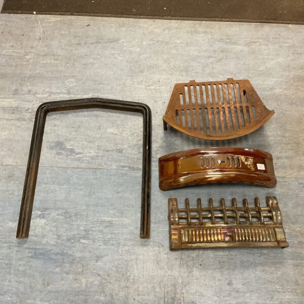 Antique cast iron fireplace fender and surround for hearth protection.