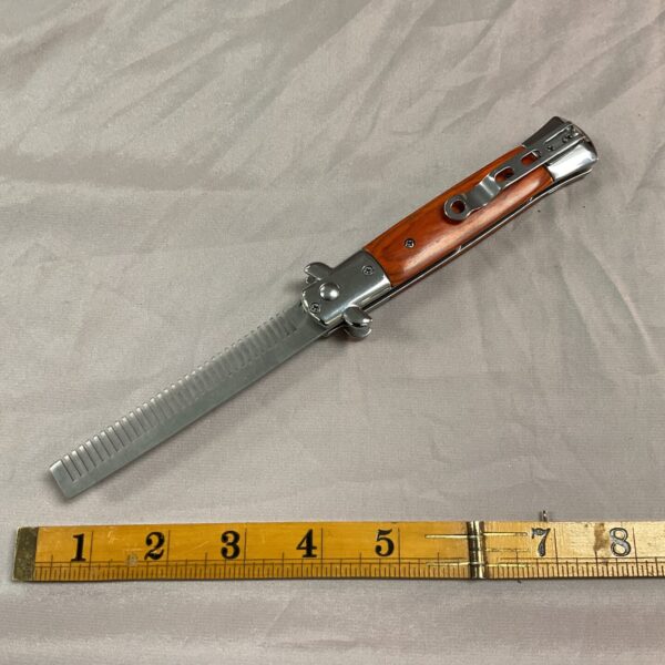 Silver tone vintage folding pocket comb for grooming.