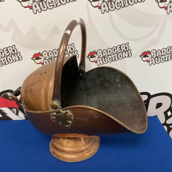 Vintage copper coal scuttle with handle, antique fireside accessory.
