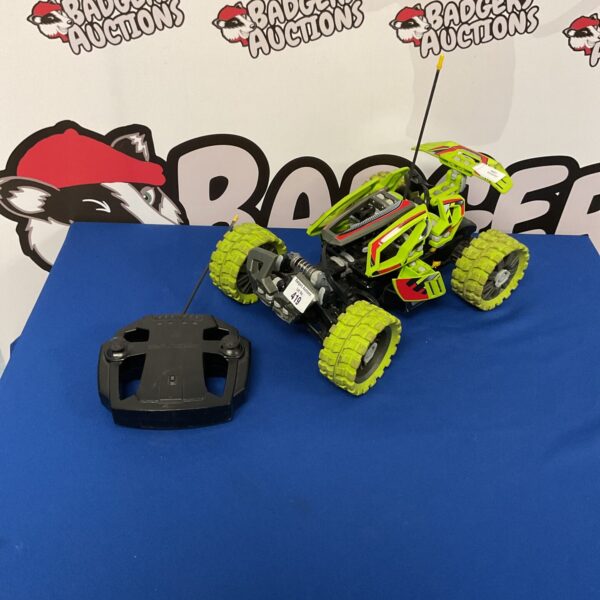 Lego RC racer remote control car with remote in hand.