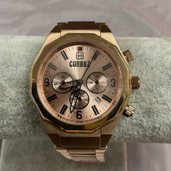 Gold-tone Curbbz quartz wristwatch with analog display.