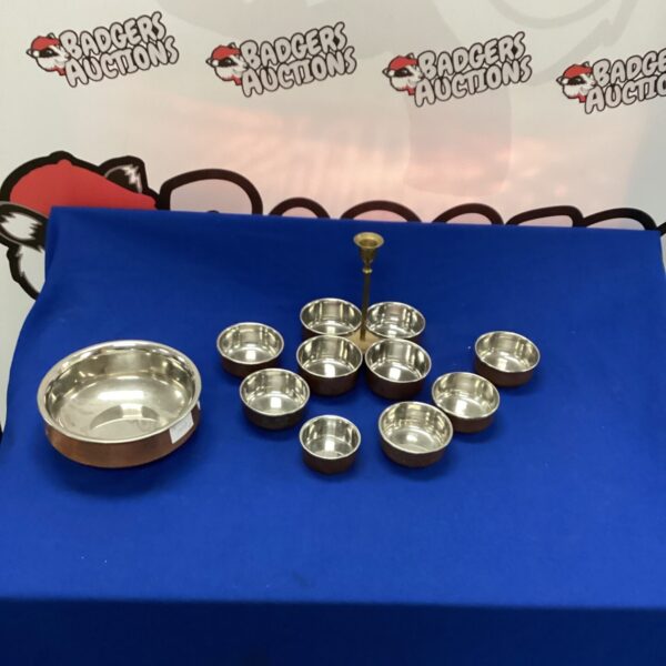Stainless steel balti dish set for serving Indian cuisine.