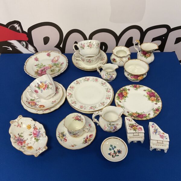 Royal Albert Old Country Rose china collection with cups, saucers, and creamers.