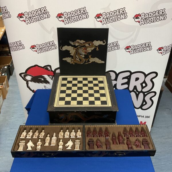Detailed Chinese terracotta warrior chess set on a wooden board.