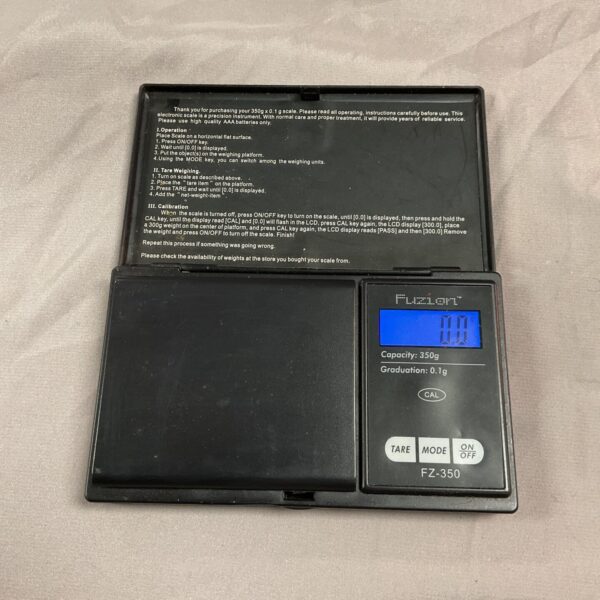 Close-up of a Fuzion digital kitchen scale with a clear display.