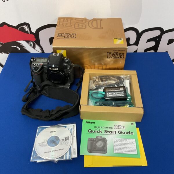Nikon D2H camera in its original box with accessories.