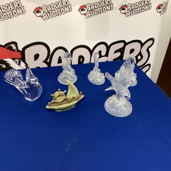 Vintage cut glass ornaments and miniature ship on display.