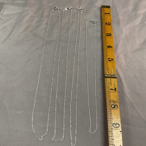 Lot of four delicate 925 silver chain necklaces.