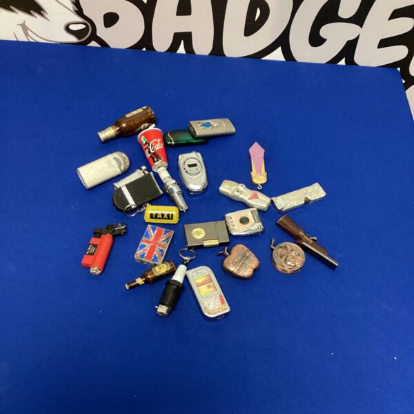 Collection of vintage novelty lighters, including a Becks beer lighter.