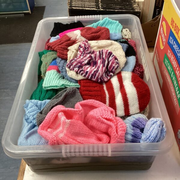 Colourful lot of hand-knitted bobble hats for winter.