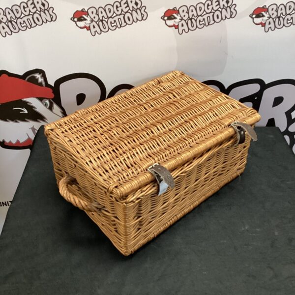 Vintage small wicker basket with a sturdy handle.