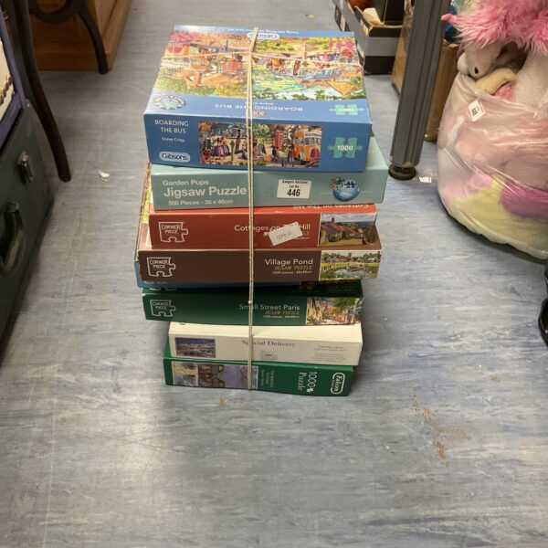 Mixed lot of jigsaw puzzles including a corner piece for family fun.