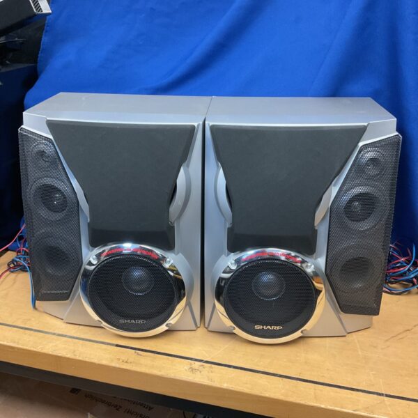 Pair of vintage Sharp powered subwoofer speakers for home audio.