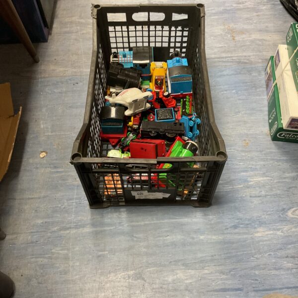 A box of Thomas the Tank Engine trains and wooden railway pieces.