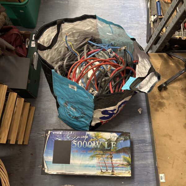 Power inverter with assorted electrical cables and connectors.