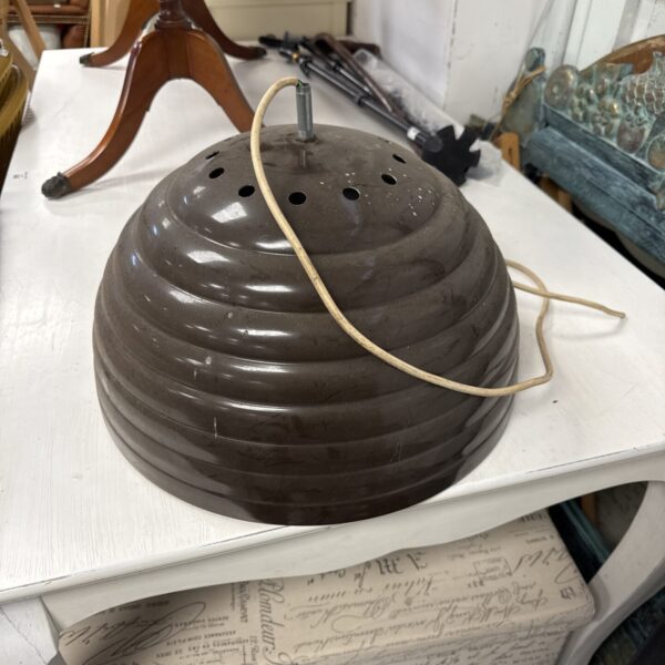 Vintage industrial enamel ceiling light with perforated shade.