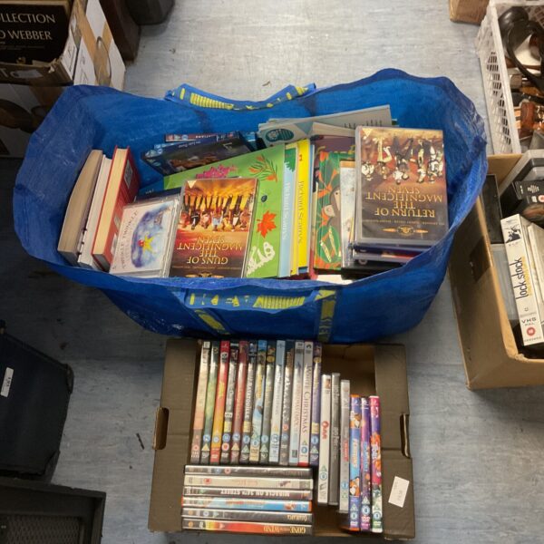 Large sack filled with a collection of children's books and DVDs.