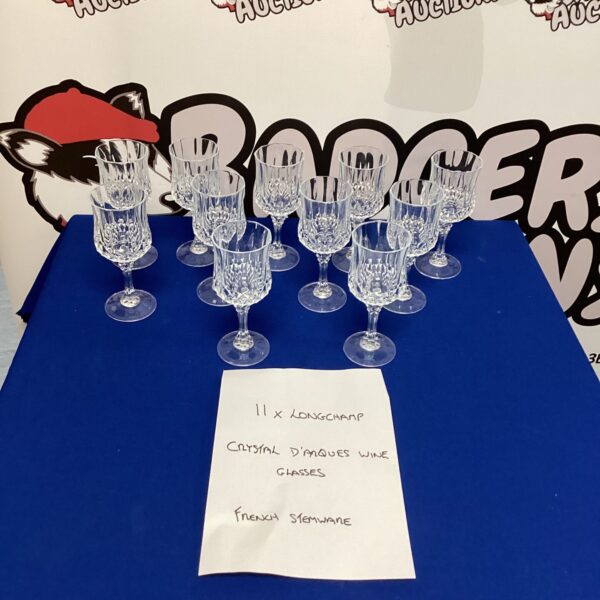 Lot of eleven Longchamp crystal wine glasses on display.