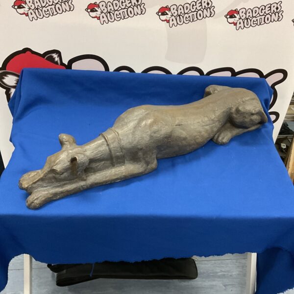 Front view of a grey resin greyhound sculpture.