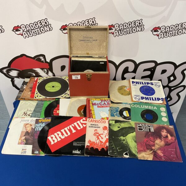 Vintage lot of 7 inch vinyl records in a carrying case.