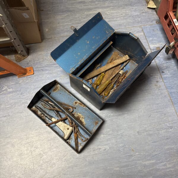 Open vintage cantilever toolbox displaying tools inside.