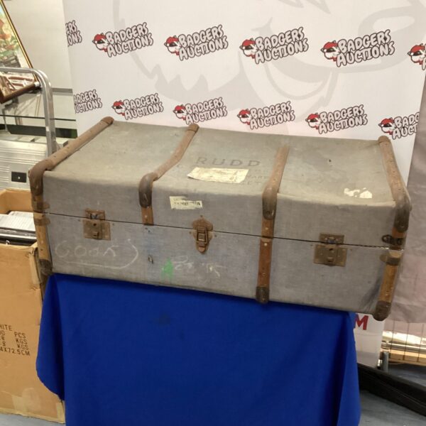 Vintage travel trunk with faded GWR railway sticker, antique luggage.