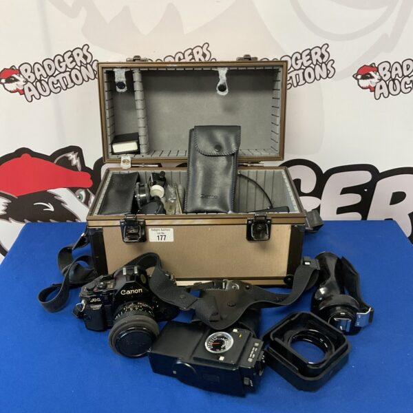 Vintage Canon A-1 film camera with accessories displayed.