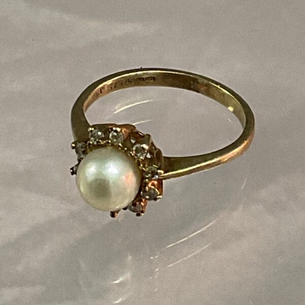 Close-up of a 9ct gold pearl and diamond ring.
