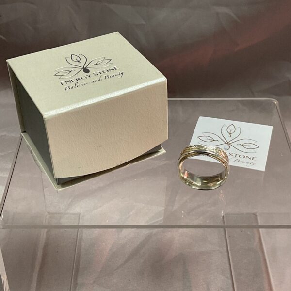 Silver spinner ring size U with energy stone detail.