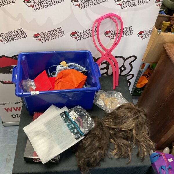Blue box filled with assorted hair extensions and wigs.