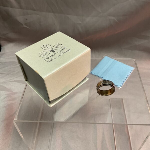Silver spinner ring size O with energy stone detail.