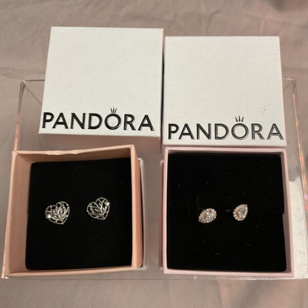 Close-up of Pandora silver stud earrings in a presentation box.