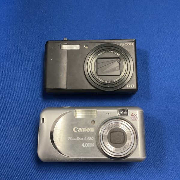 Vintage Ricoh R8 and Canon A430 digital cameras for collectors.