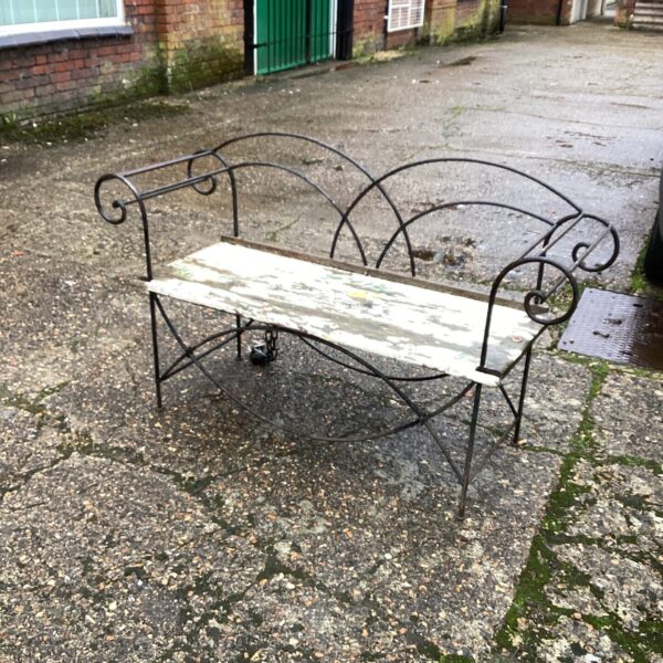 Vintage metal and wood garden bench with scrolled detailing.