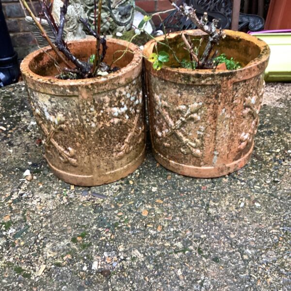 Two weathered stone effect garden planters for outdoor use.