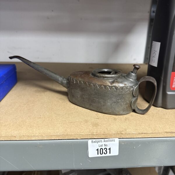 Vintage half-pint oil can with metal construction and weathered patina.