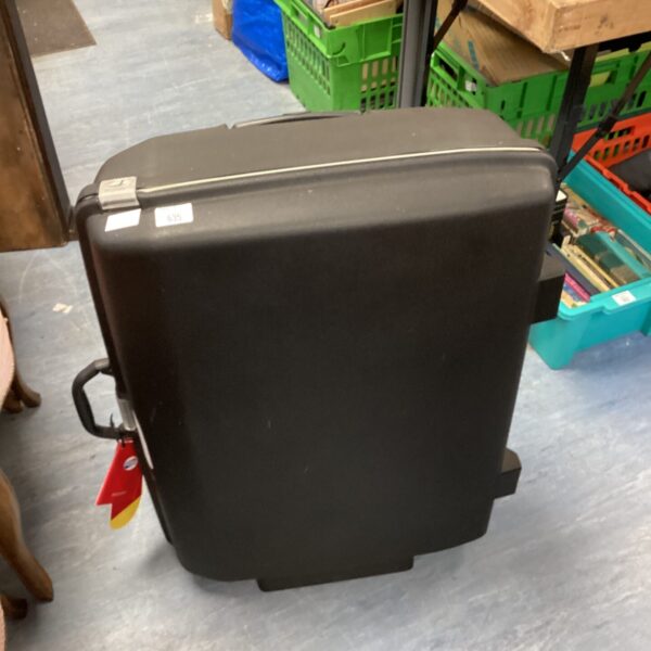 New black American Tourister wheeled suitcase with tags.
