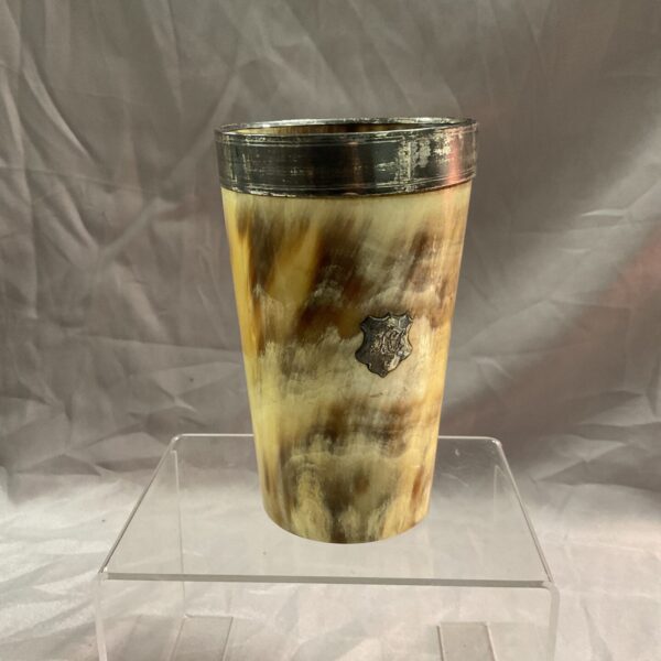 Antique horn beaker with silver rim, a vintage drinking vessel.