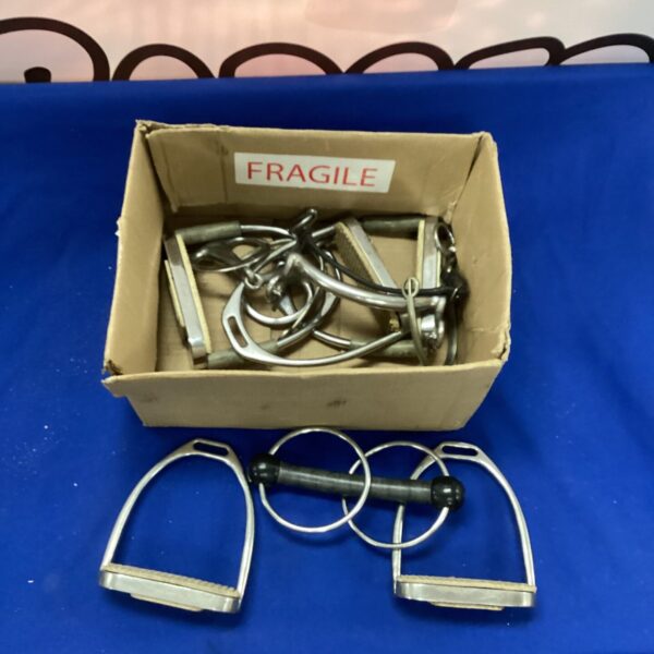 Vintage metal horse stirrups in a cardboard box.