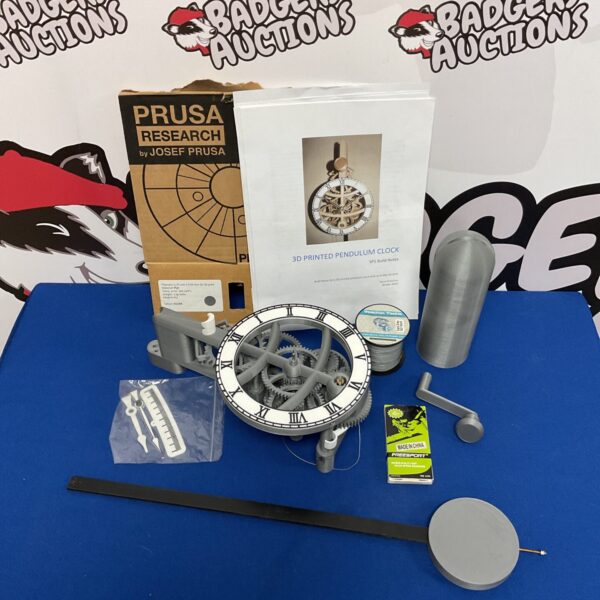 Prusa Research 3D printed pendulum clock kit components laid out for assembly.