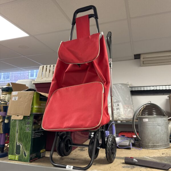 Blue granny shopping trolley with wheels for carrying groceries.