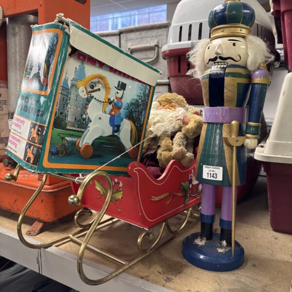 Vintage wooden nutcracker and Santa sleigh Christmas decoration.