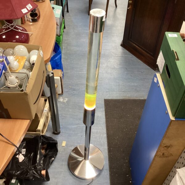 Stainless steel lava lamp with flowing wax, retro style lighting.