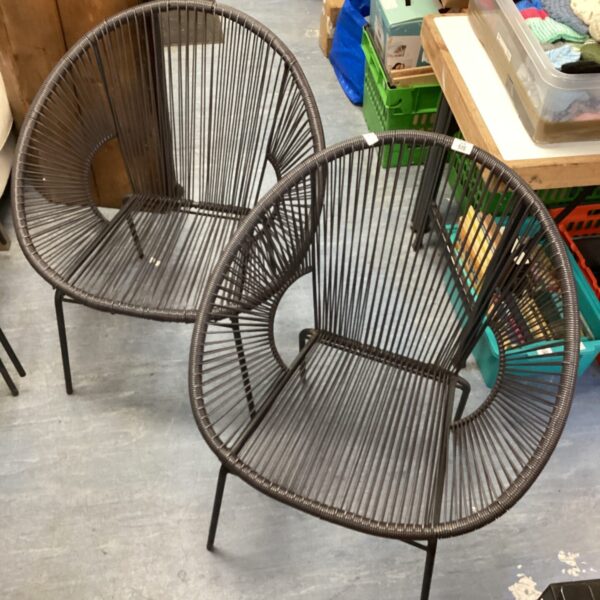 Two black string egg chairs with woven string construction.